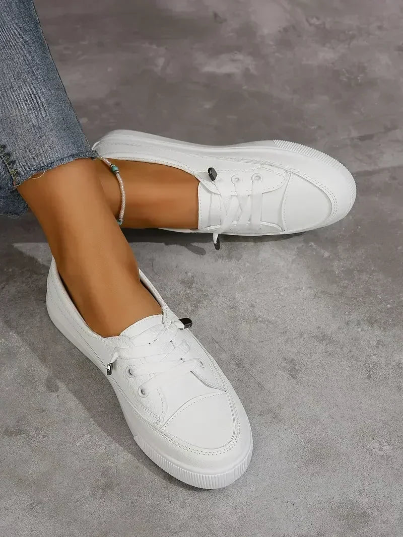 Women's everyday white casual lace-up flats. Round toe, comfortable and easy to wear women's footwear.