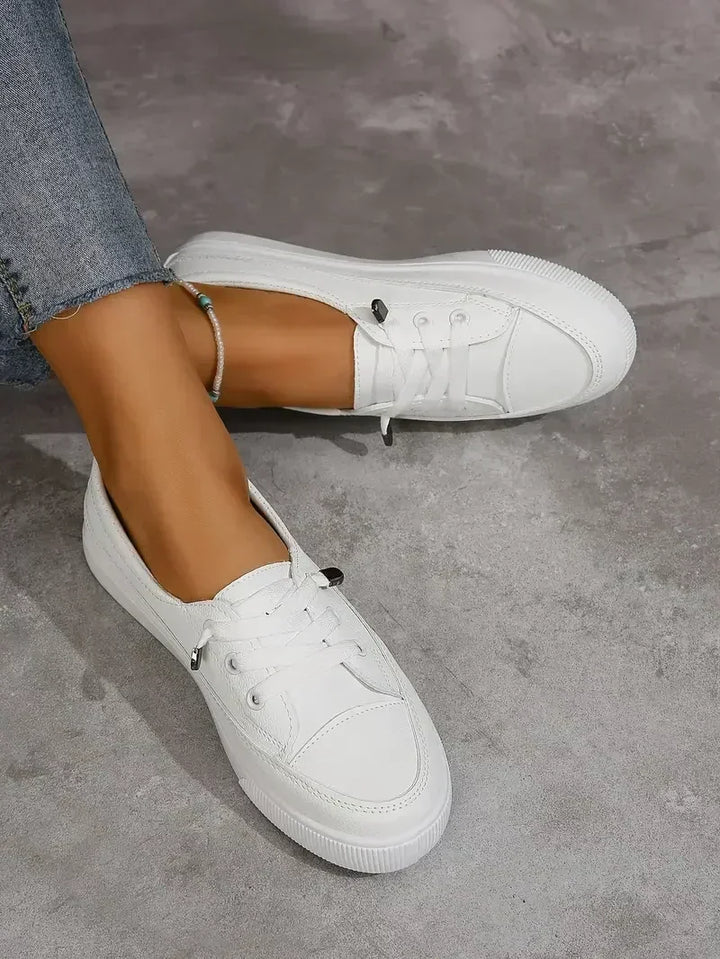 Women's everyday white casual lace-up flats. Round toe, comfortable and easy to wear women's footwear.