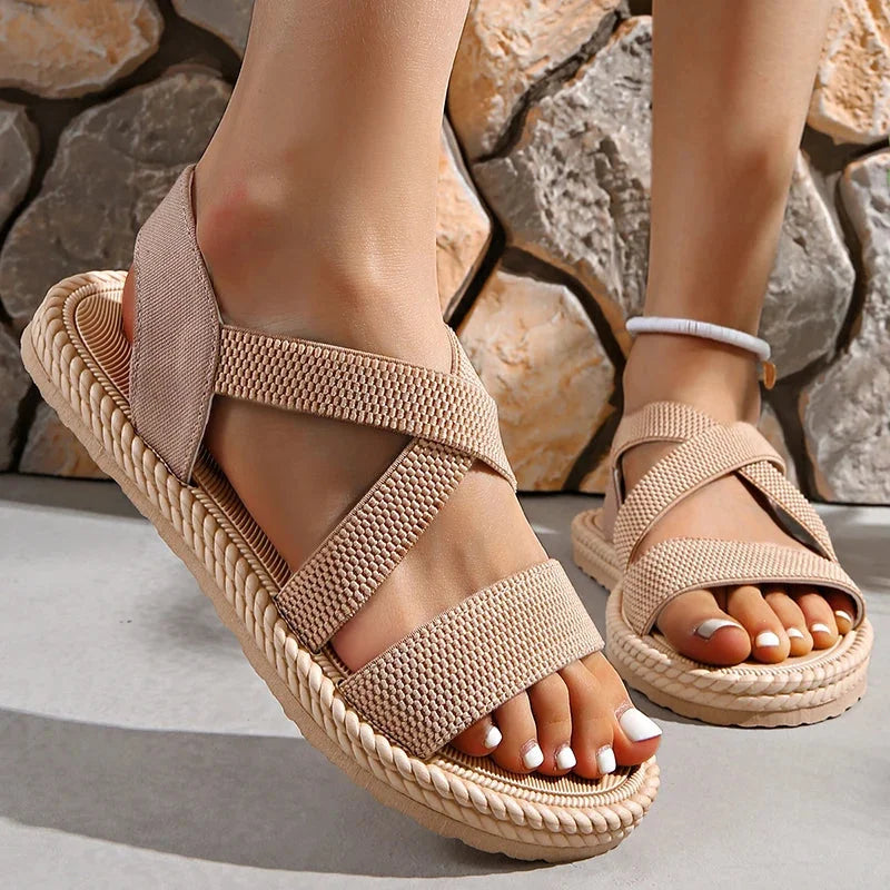 Women's comfortable woven espadrille sandals with braided sole & elastic criss-cross straps, perfect for summer.