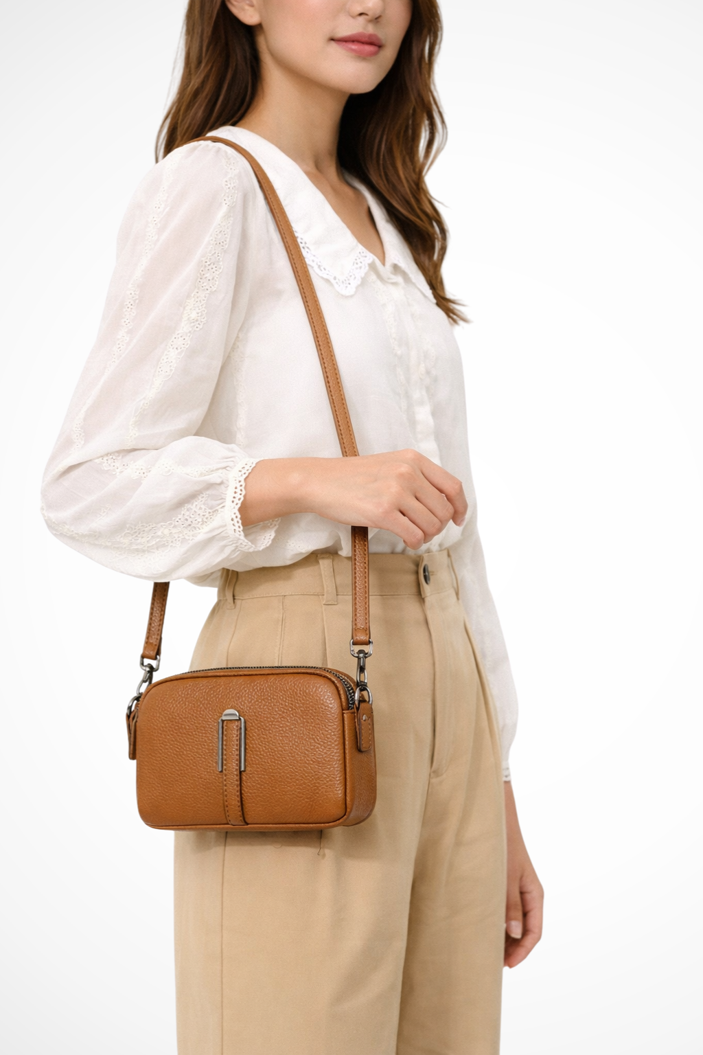 Women's compact double zip crossbody bag with textured finish, perfect for everyday style.