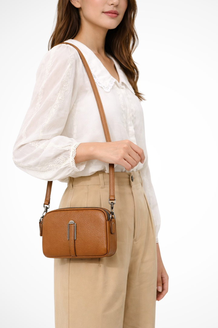 Women's compact double zip crossbody bag with textured finish, perfect for everyday style.