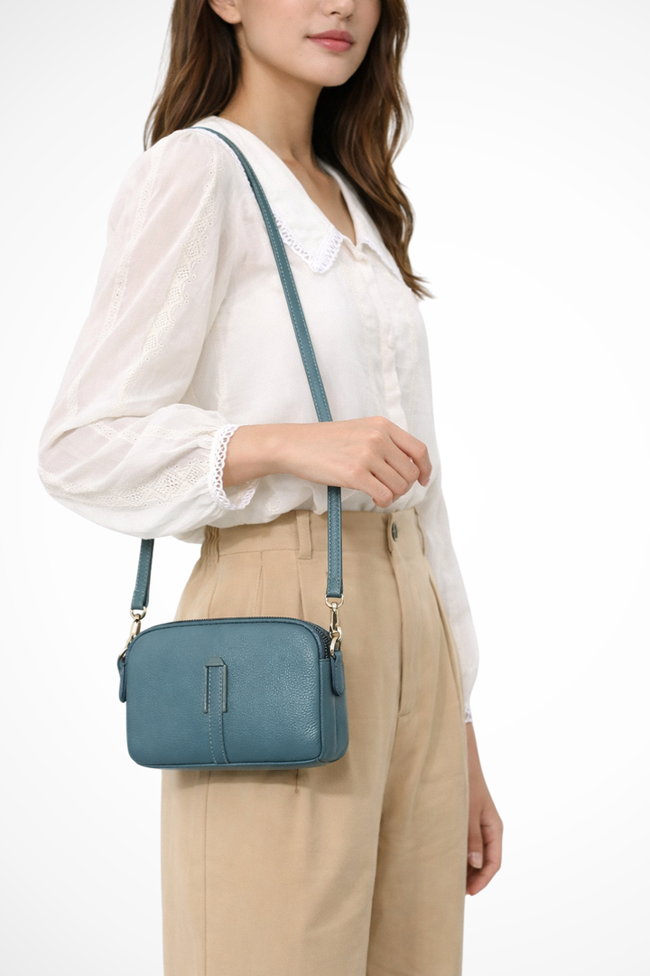 Small women's double zip crossbody bag, a compact and practical textured purse for essential items.