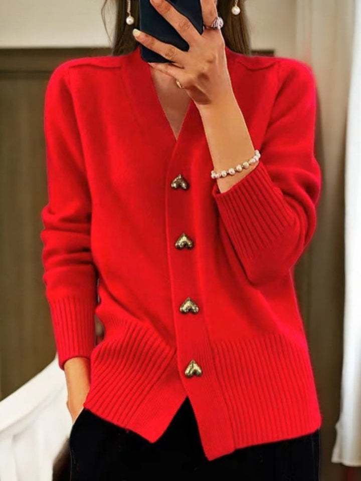 Women's elegant knit button-up cardigan. Long-sleeve cozy top for winter warmth and stylish casual wear.