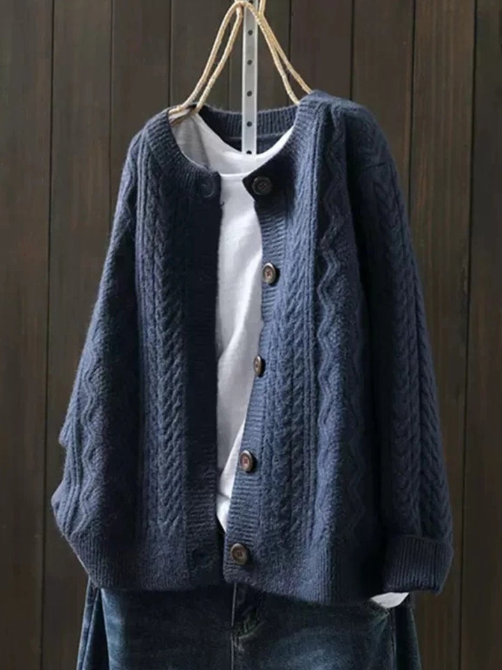 Women's comfy button-down cable-knit cardigan, a cozy and stylish layering piece for relaxed elegance.