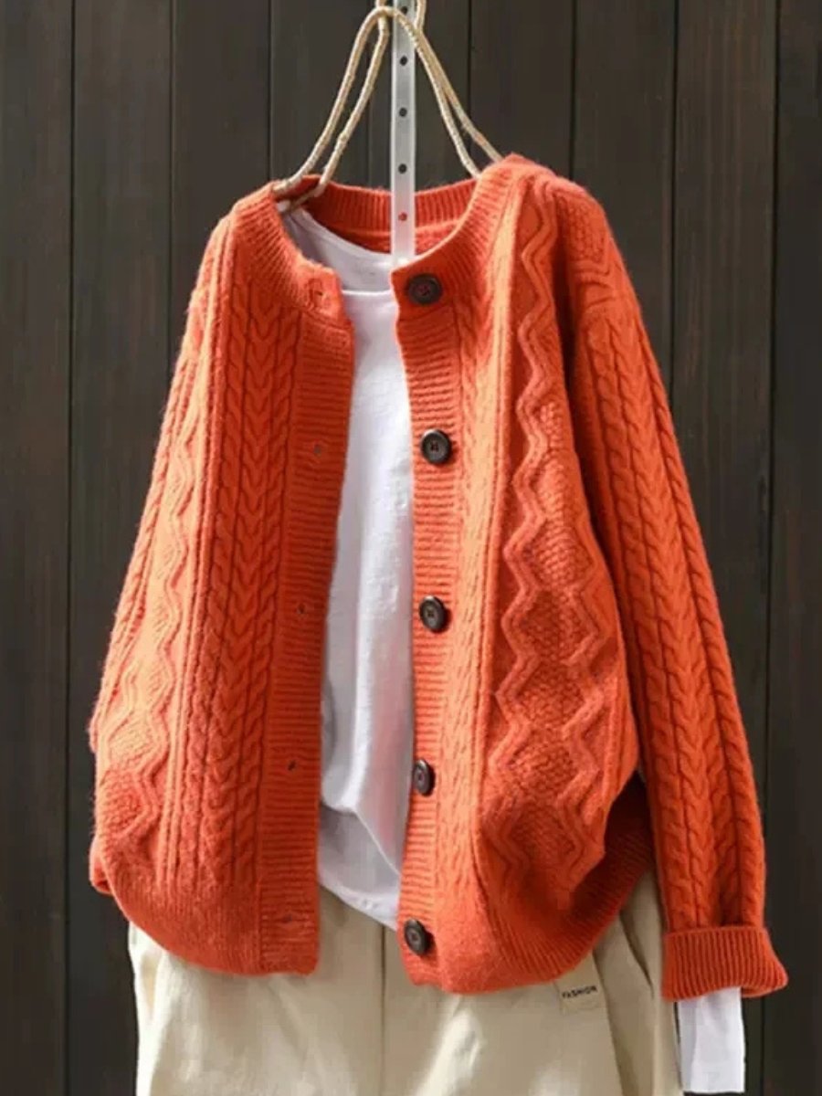 Versatile women's cable-knit cardigan featuring a button-down front, soft texture, and chic oversized fit.
