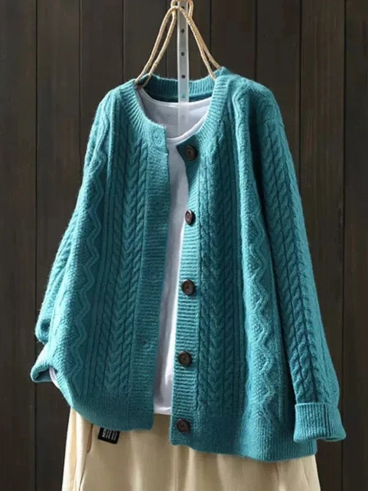 Autumn/winter women's cable-knit button-down cardigan. Cozy, relaxed fit, and elegant soft knit style.