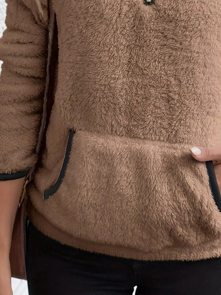 Soft women's long sleeve half-zip sweater, a cozy layering piece for winter fashion.