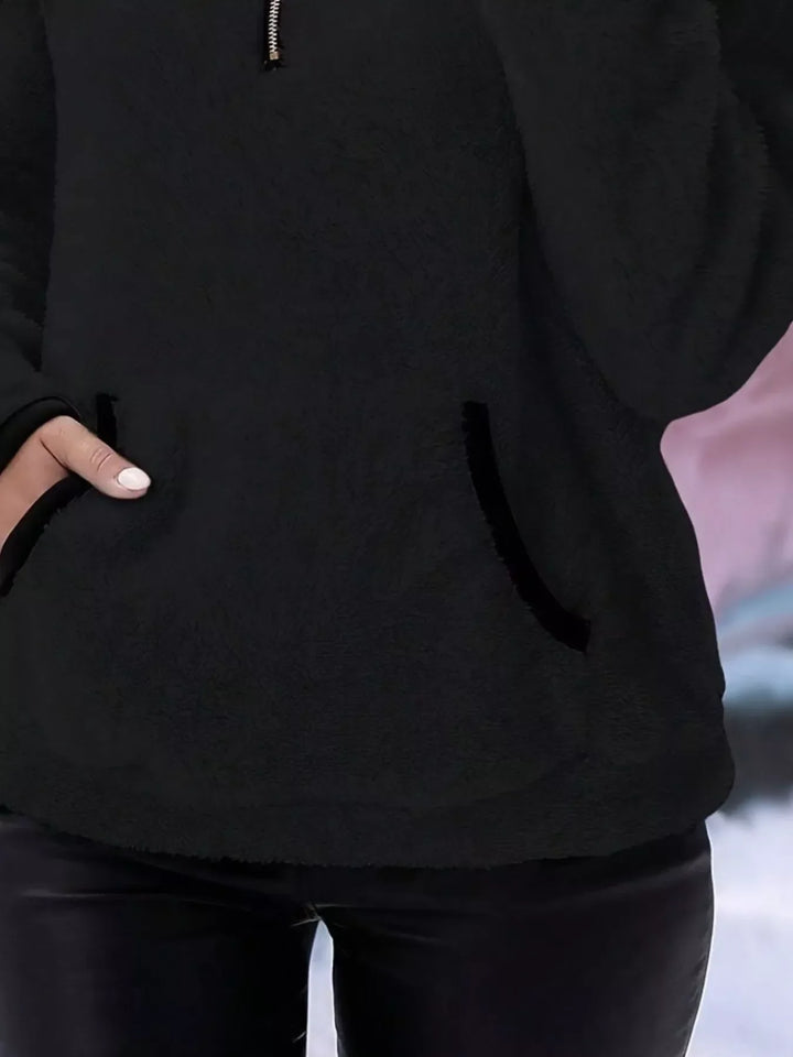 Relaxed fit women's half-zip pullover, ideal for everyday comfort and warmth.