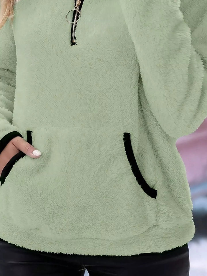 Cozy women's half-zip pullover, designed for everyday comfort and relaxed fit.