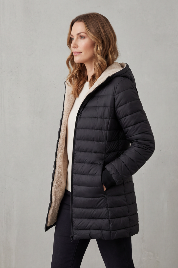 Lady wearing a stylish hooded puffer jacket, perfect for warm winter outerwear & cold weather fashion.
