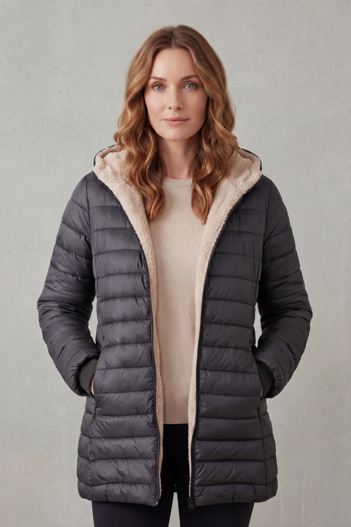 Insulated women's puffer jacket with hood, offering cozy warmth as winter outerwear for cold weather.