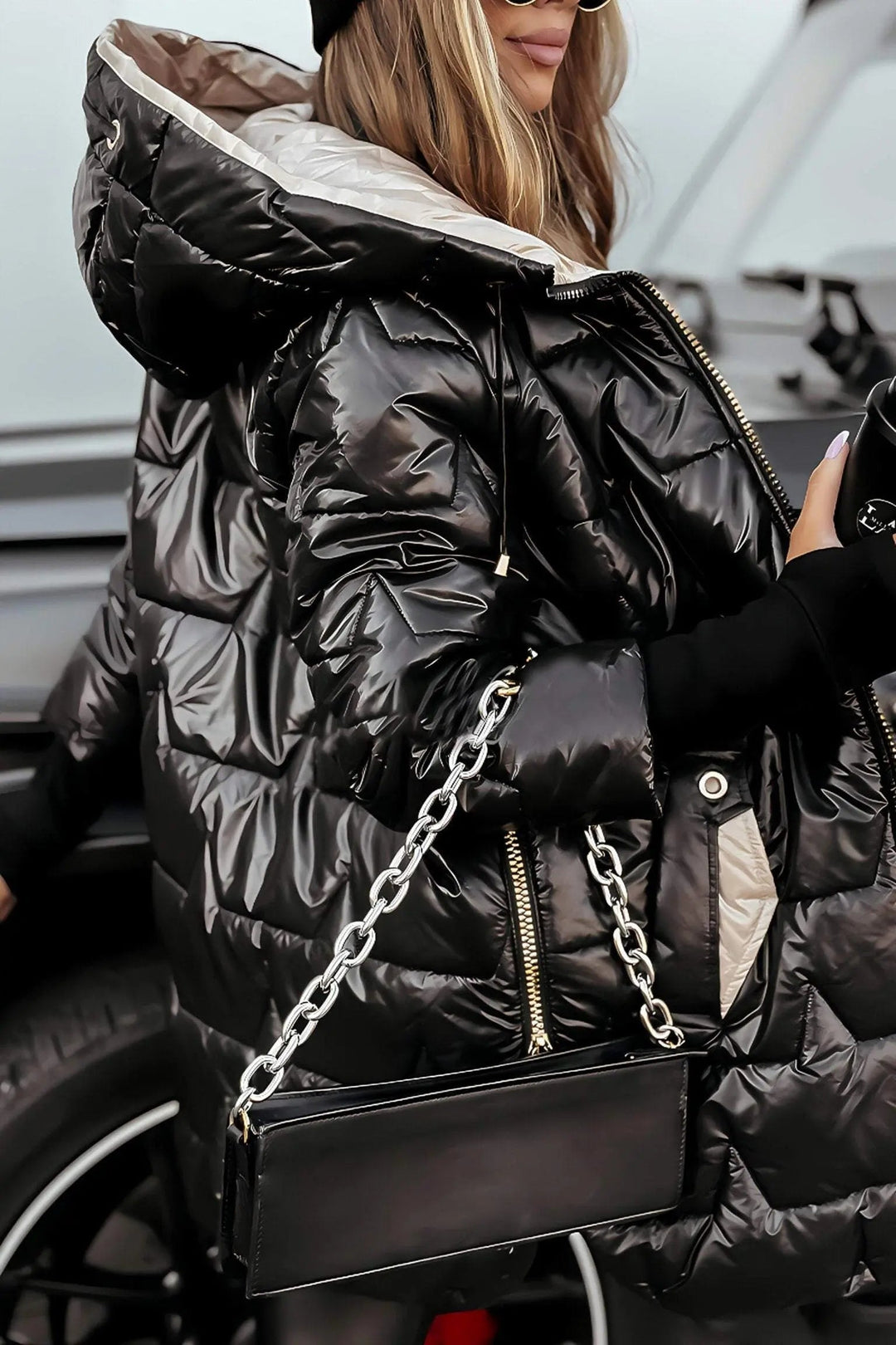 Puffy women's winter coat with hood, offering stylish and warm outerwear for cold fall and winter weather.