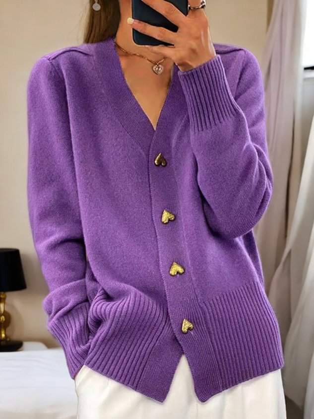 Stylish women's apparel: a long sleeve button-down cardigan featuring unique heart buttons for a cute look.
