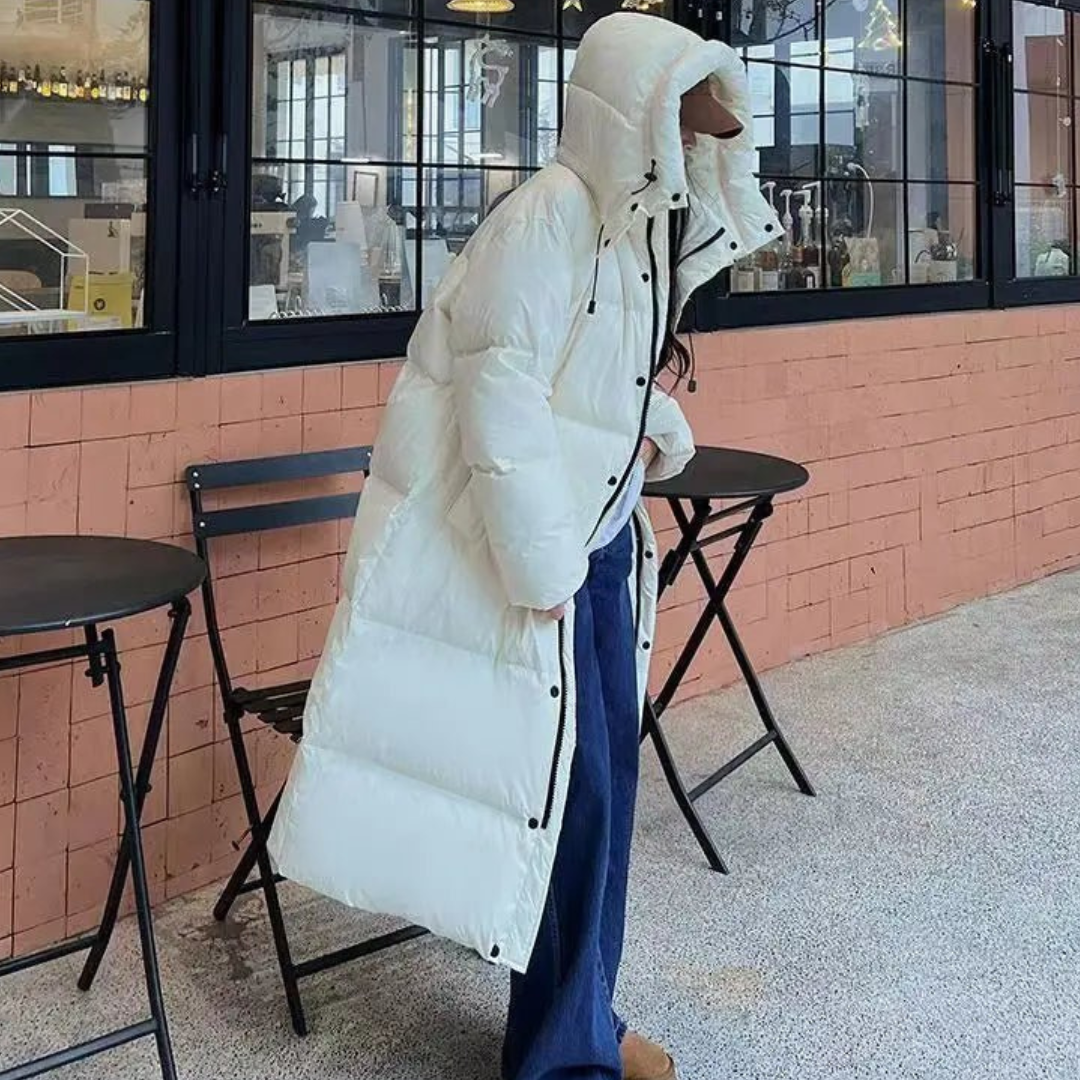 Stylish women's hooded long puffer coat. Perfect for cold weather, offering cozy warmth and modern winter fashion.