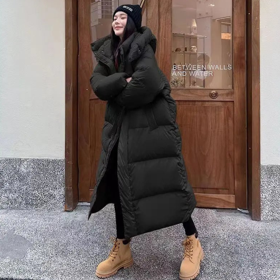 Warm women's long puffer jacket with hood. Provides excellent protection against cold, enhancing your winter style.