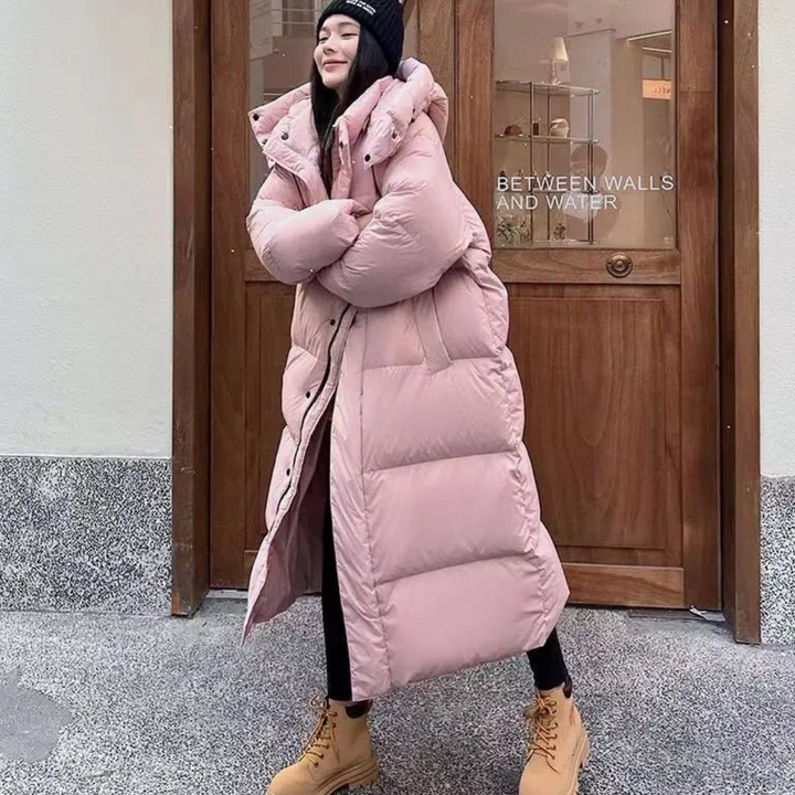 Luxurious women's long hooded puffer coat, designed for supreme warmth and cozy comfort in winter weather.