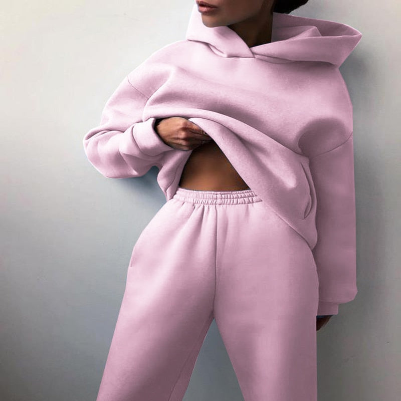 Woman wearing a comfortable matching hoodie and sweatpants set, ideal cozy loungewear.
