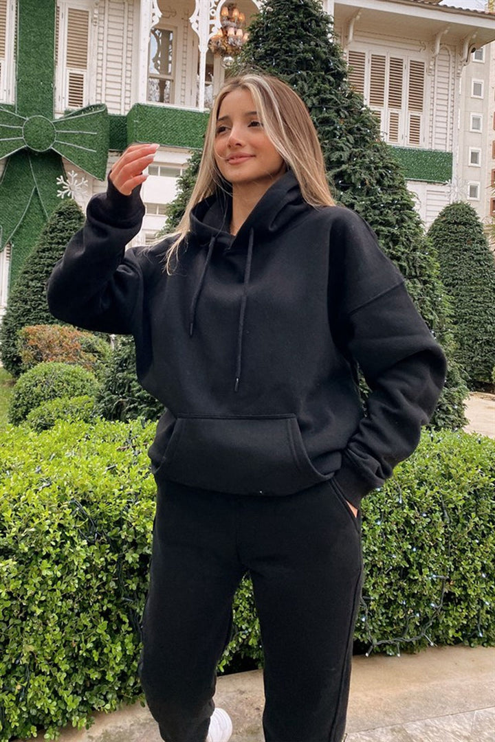 Folded women's cozy hoodie and sweatpants set, ready for comfortable everyday casual wear.