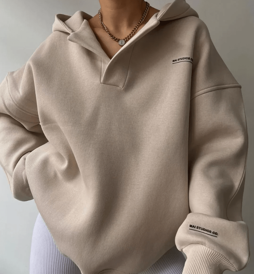 Women's cozy oversized pullover hoodie with stylish notch neck and drop shoulder design.