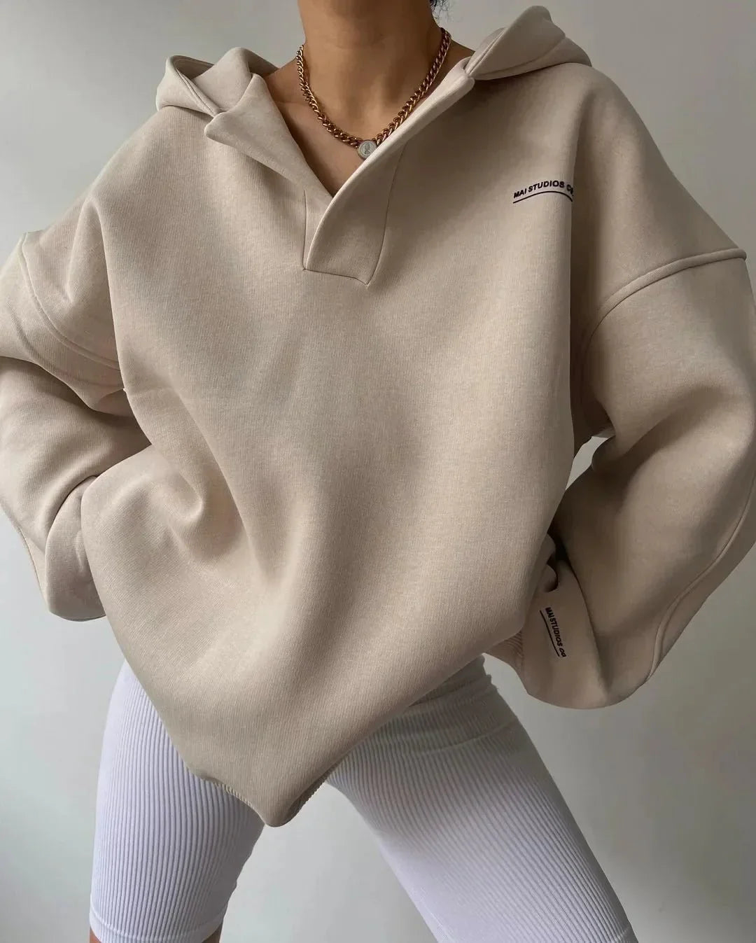 Trendy women's oversized pullover hoodie featuring a unique notch neck and drop shoulder for modern style.