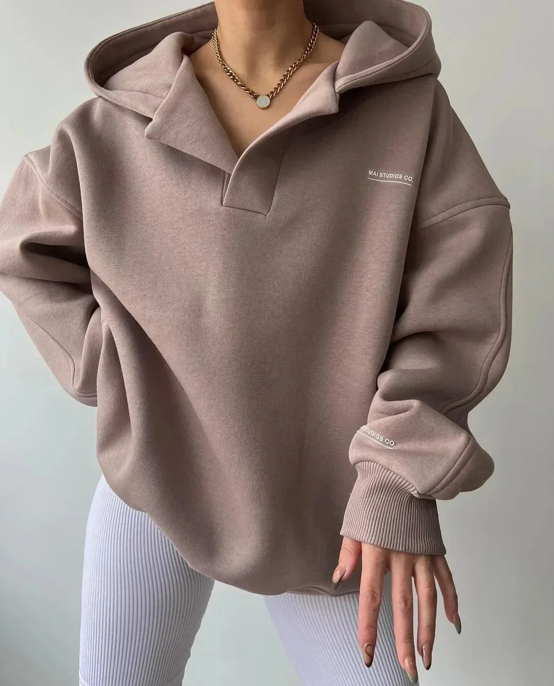 Ultimate comfort in this women's oversized pullover hoodie with a cozy feel and stylish notch neck.