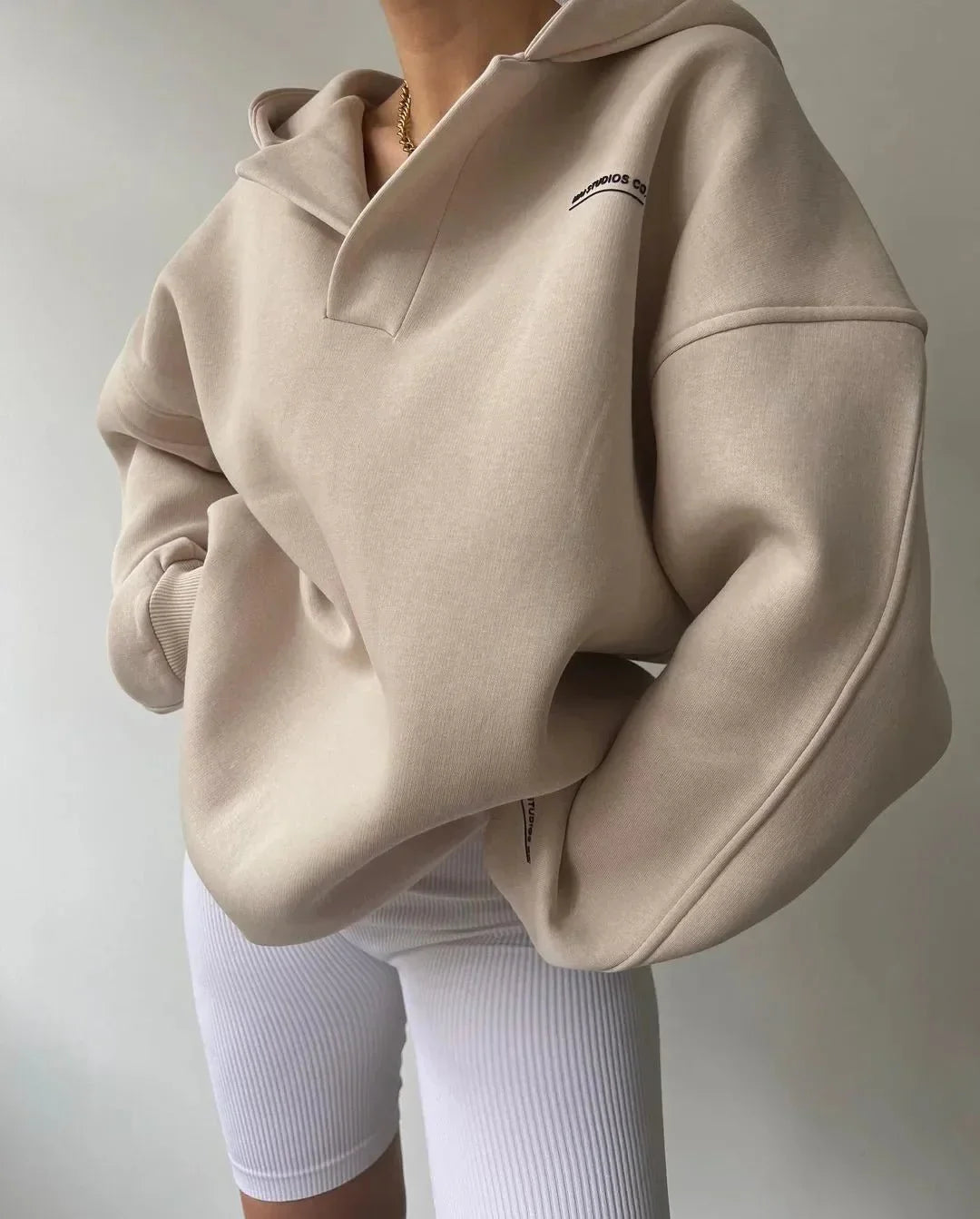 Women's cozy oversized pullover hoodie with a chic notch neck, drop shoulder, and soft fabric for casual wear.