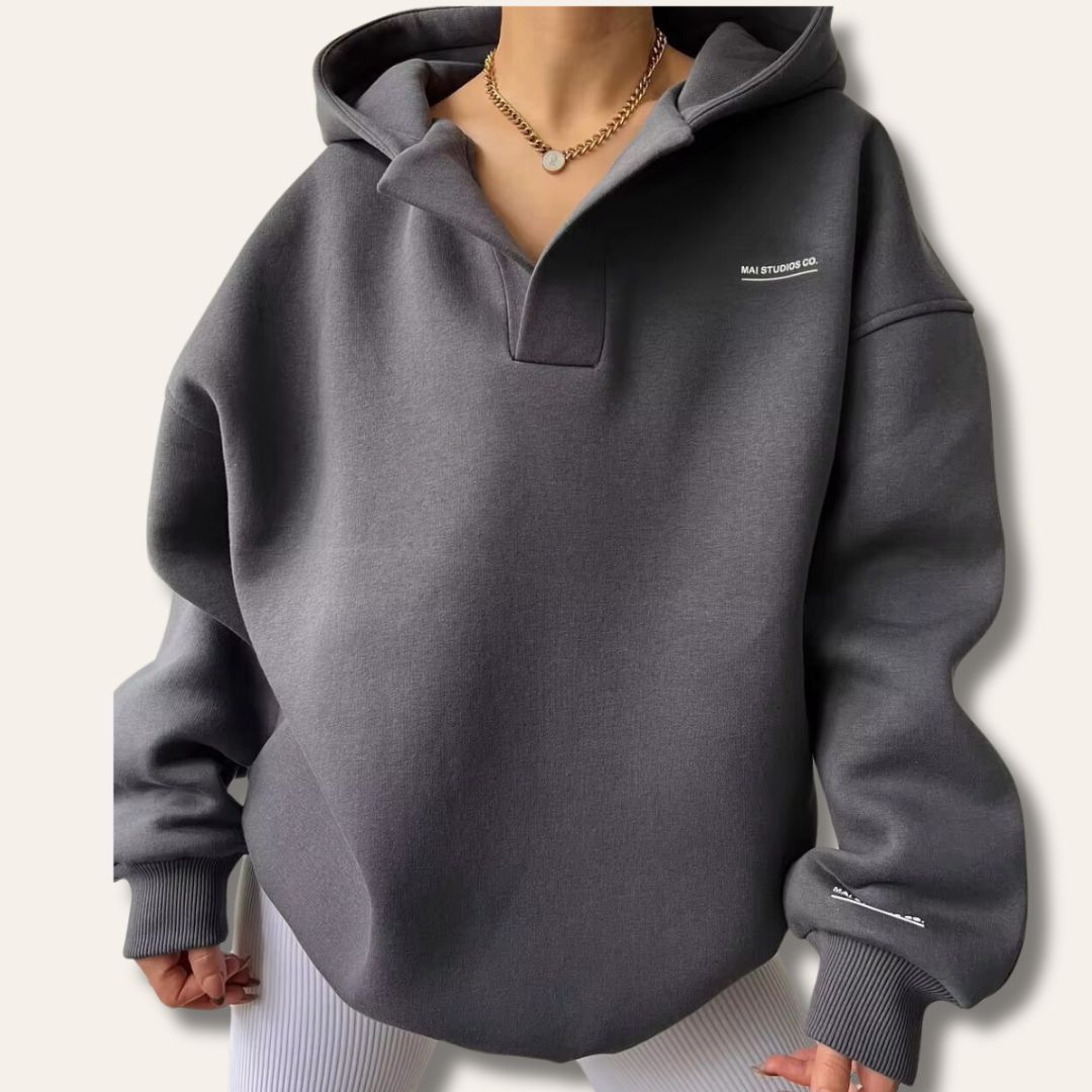 Comfortable women's oversized hoodie, perfect for casual wear & loungewear. Features cozy fabric & notch neck.