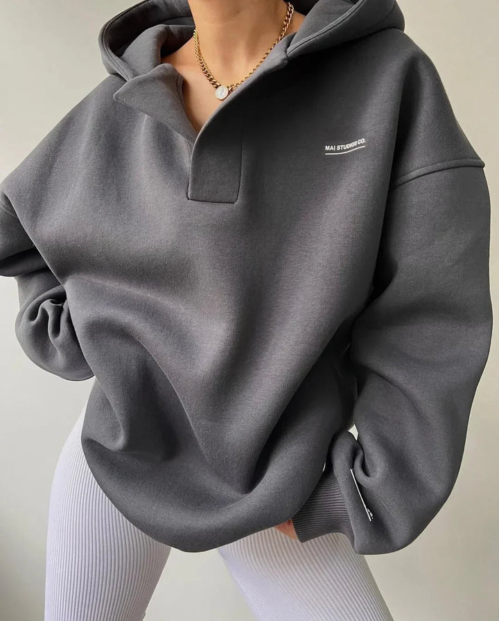 Soft, oversized women's hoodie featuring a unique notch neck. Great for cozy fashion and casual comfort.