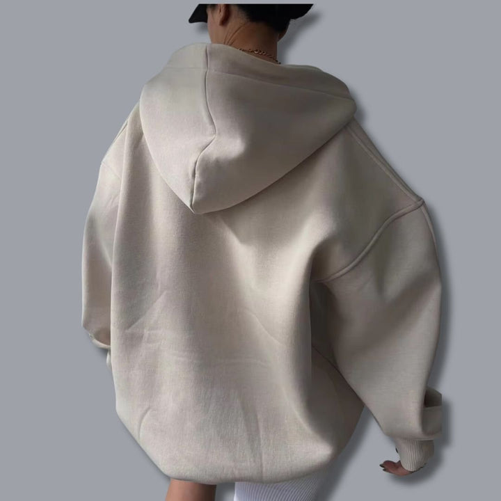 Women's oversized pullover hoodie with cozy fabric and a flattering notch neck for casual elegance.