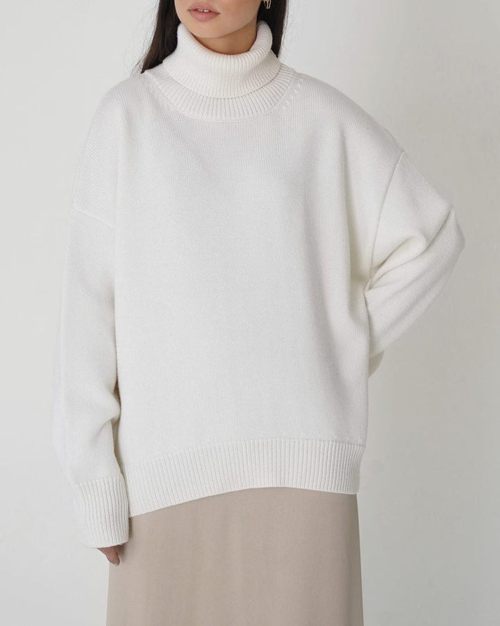 Stylish women's oversized turtleneck sweater with drop shoulder design for comfortable wear.