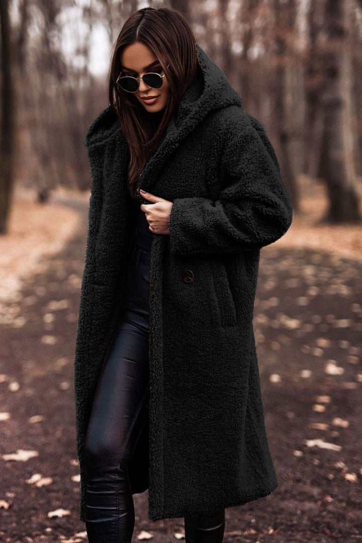 Relaxed fit women's long hooded teddy coat with patch pockets for ultimate winter comfort.