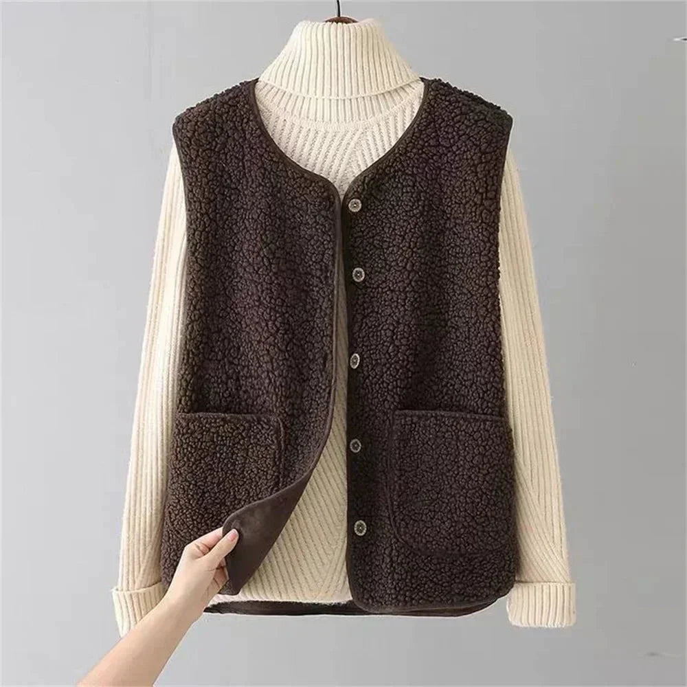 Chic women's sherpa vest featuring a button-front, V-neck, and practical patch pockets. Winter warmth.