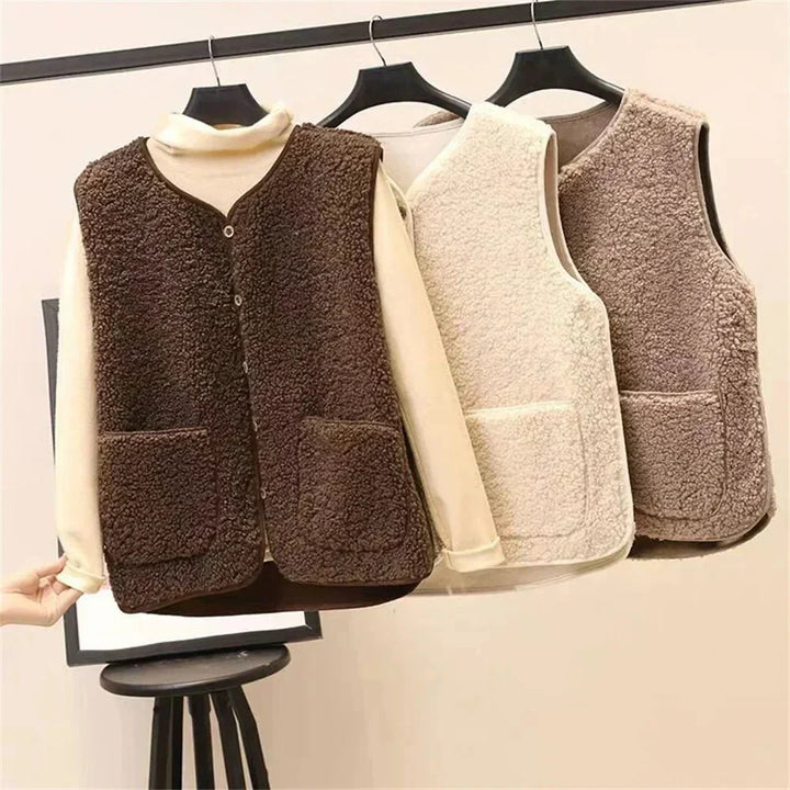 Fashionable women's sherpa vest, ideal for layering. Button-front, V-neck, and spacious patch pockets.