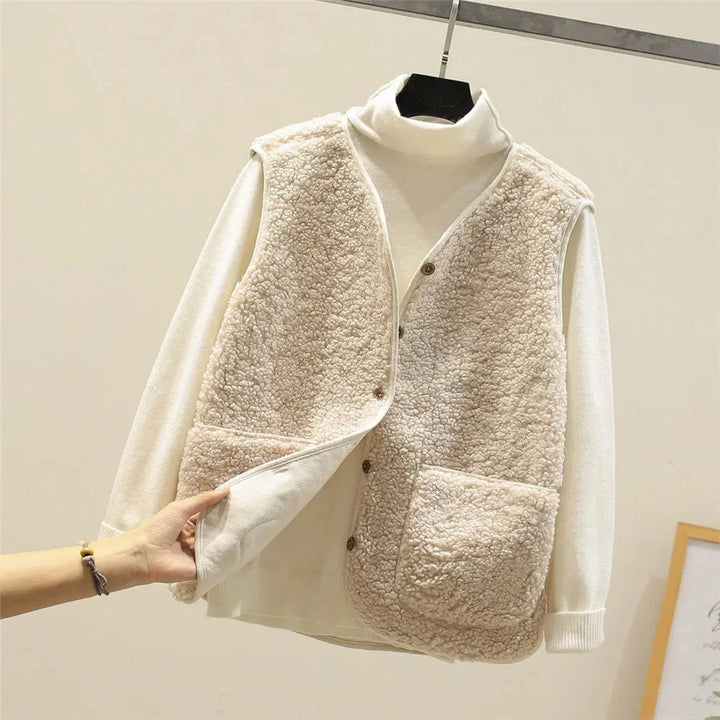 Women's sherpa vest for ultimate warmth. Button-front, V-neck, and convenient patch pockets. Winter style.