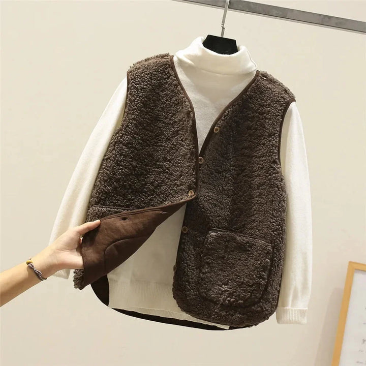 Elevate your look with this women's sherpa vest, button-front, V-neck, & chic patch pockets. Cozy.