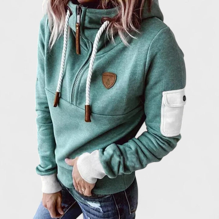 Woman relaxing in a black cozy soft zip neck hoodie. Comfortable casual pullover for women.