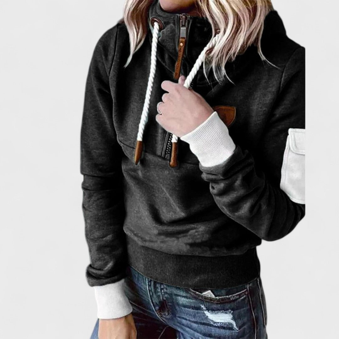 Close-up of soft texture on a women's grey cozy hoodie, modern zip neck. Comfortable casual jumper.