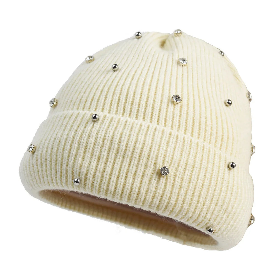 Warm women's headwear, a cozy knit beanie with a sparkling rhinestone design and a practical fold-over cuff.
