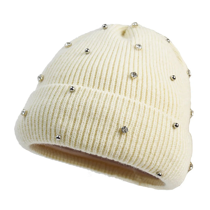 Warm women's headwear, a cozy knit beanie with a sparkling rhinestone design and a practical fold-over cuff.