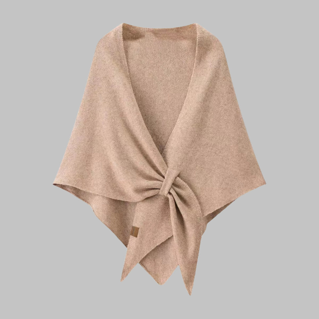 Woman wearing elegant striped triangle shawl. Cozy fashion wrap for versatile styling.