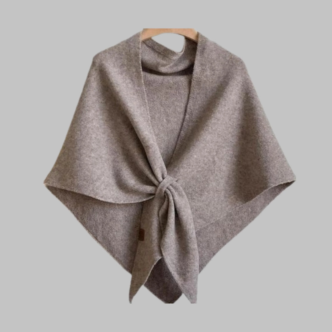 Close-up of soft striped fabric on a women's triangle shawl. Cozy and elegant fashion wrap.