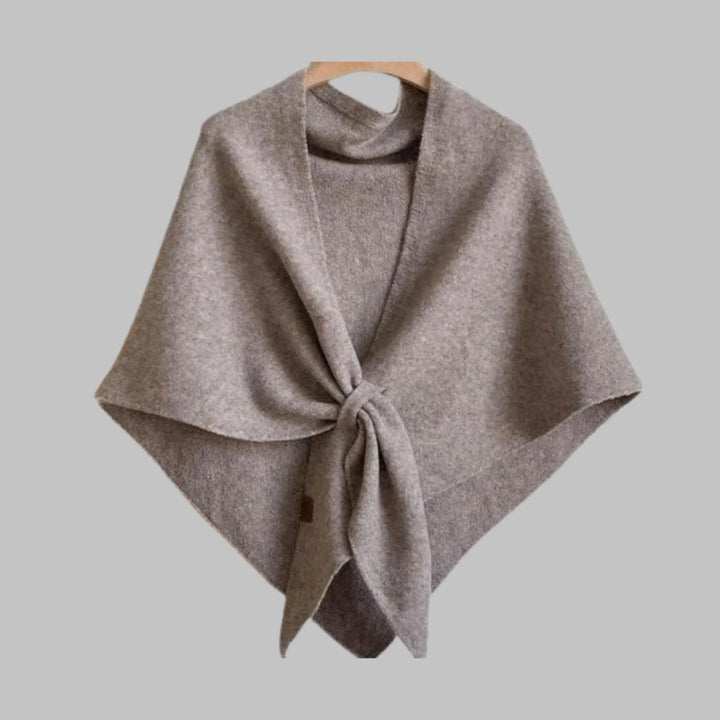 Close-up of soft striped fabric on a women's triangle shawl. Cozy and elegant fashion wrap.