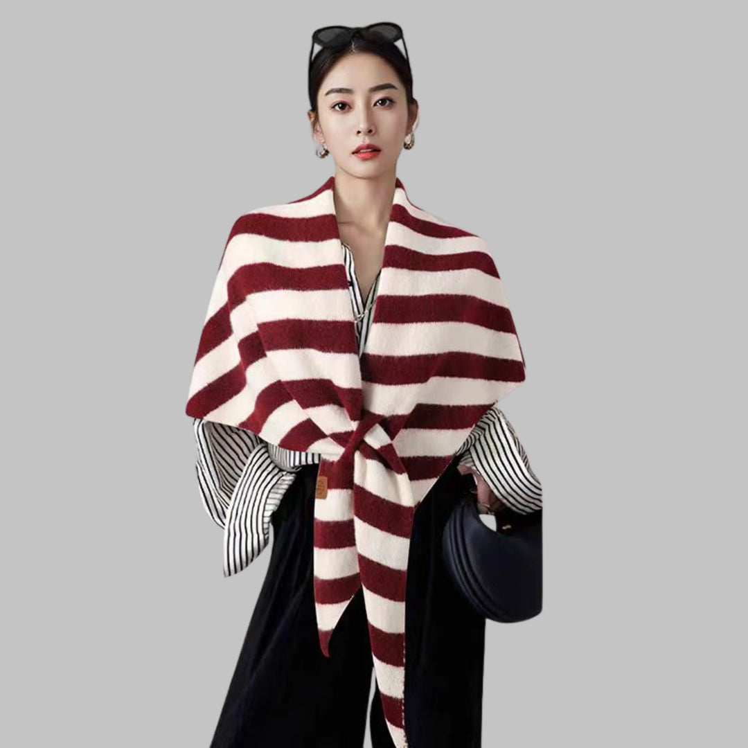 Women's cozy striped triangle shawl draped. Versatile wrap for elegant style & warmth.