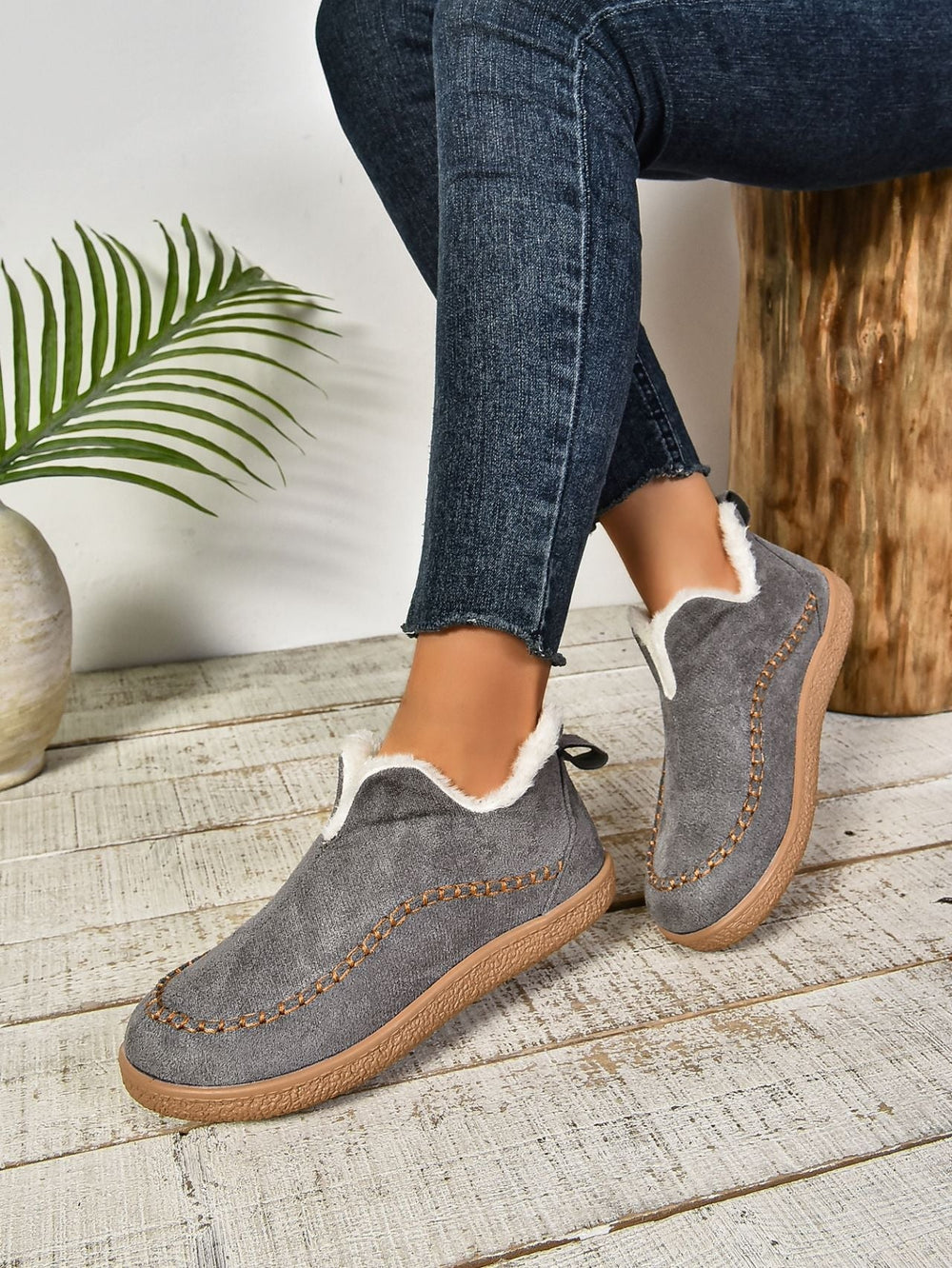 Soft and warm slip-on house shoes for women, perfect for relaxing at home.