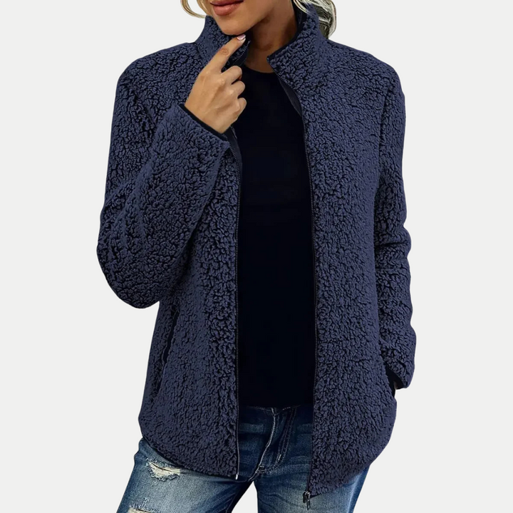 Cozy women's zip-up jacket with a unique textured pattern and high collar for warmth and style.
