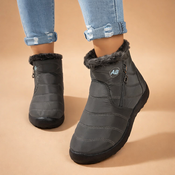 Sleek zip-up ankle boots for women. Cozy winter footwear offering warmth, comfort, and stylish protection.