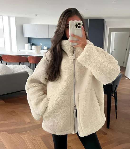 Women's cozy zip-up winter jacket in a warm beige, perfect for everyday cold weather style and layering.