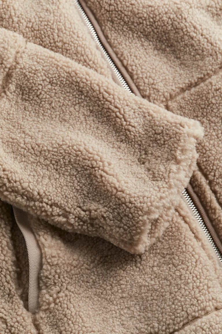 Warm women's outerwear, a cozy zip-up winter jacket in beige, ideal for layering in cold weather.