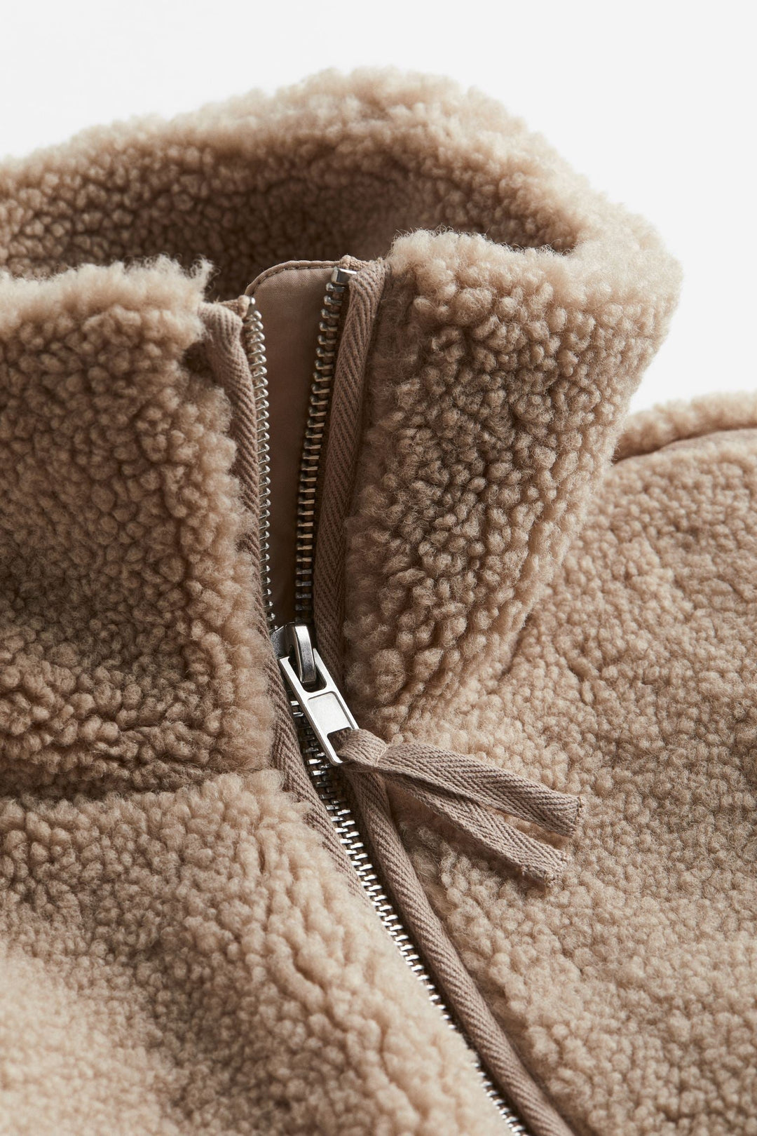 Plush women's cozy winter jacket, a stylish zip-up coat in white for ultimate warmth and comfort.