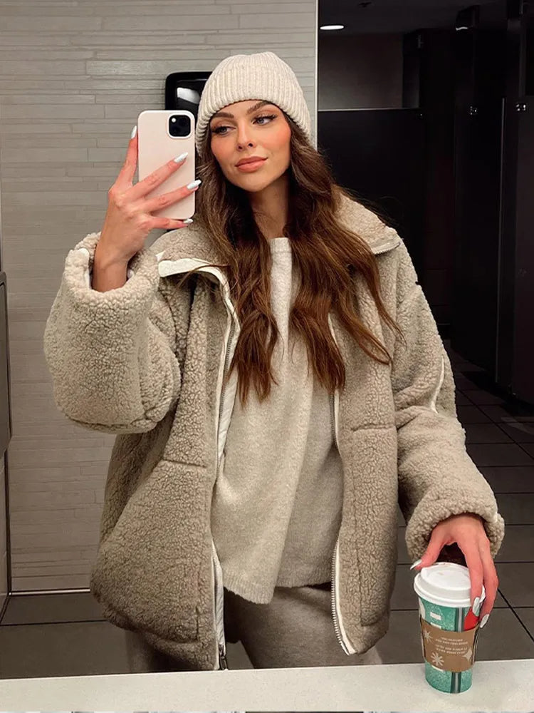 Stylish beige women's winter jacket with a full zip, offering cozy warmth and a relaxed fit for cold days.